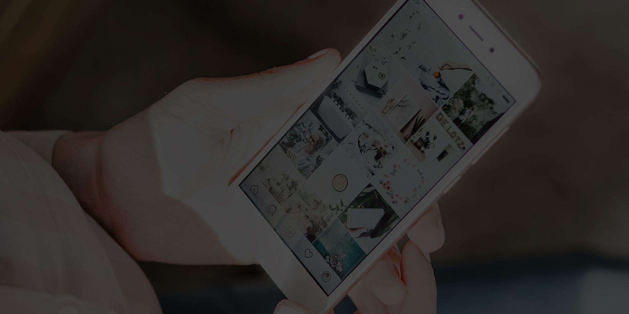Person holding a smartphone displaying Instagram feed.