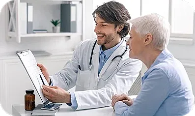 Doctor consulting with elderly patient in office.