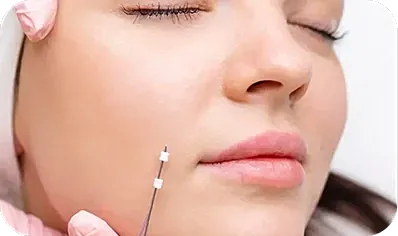 Woman receiving cosmetic treatment with syringe.