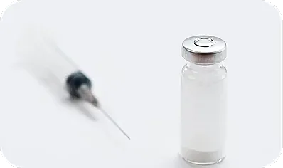 Syringe and vial with medication or vaccine.