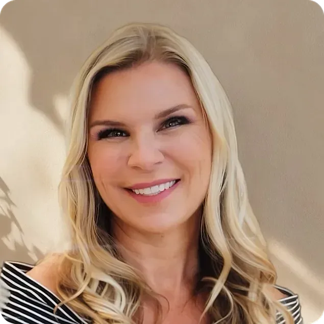 Smiling woman with long, wavy blonde hair.
