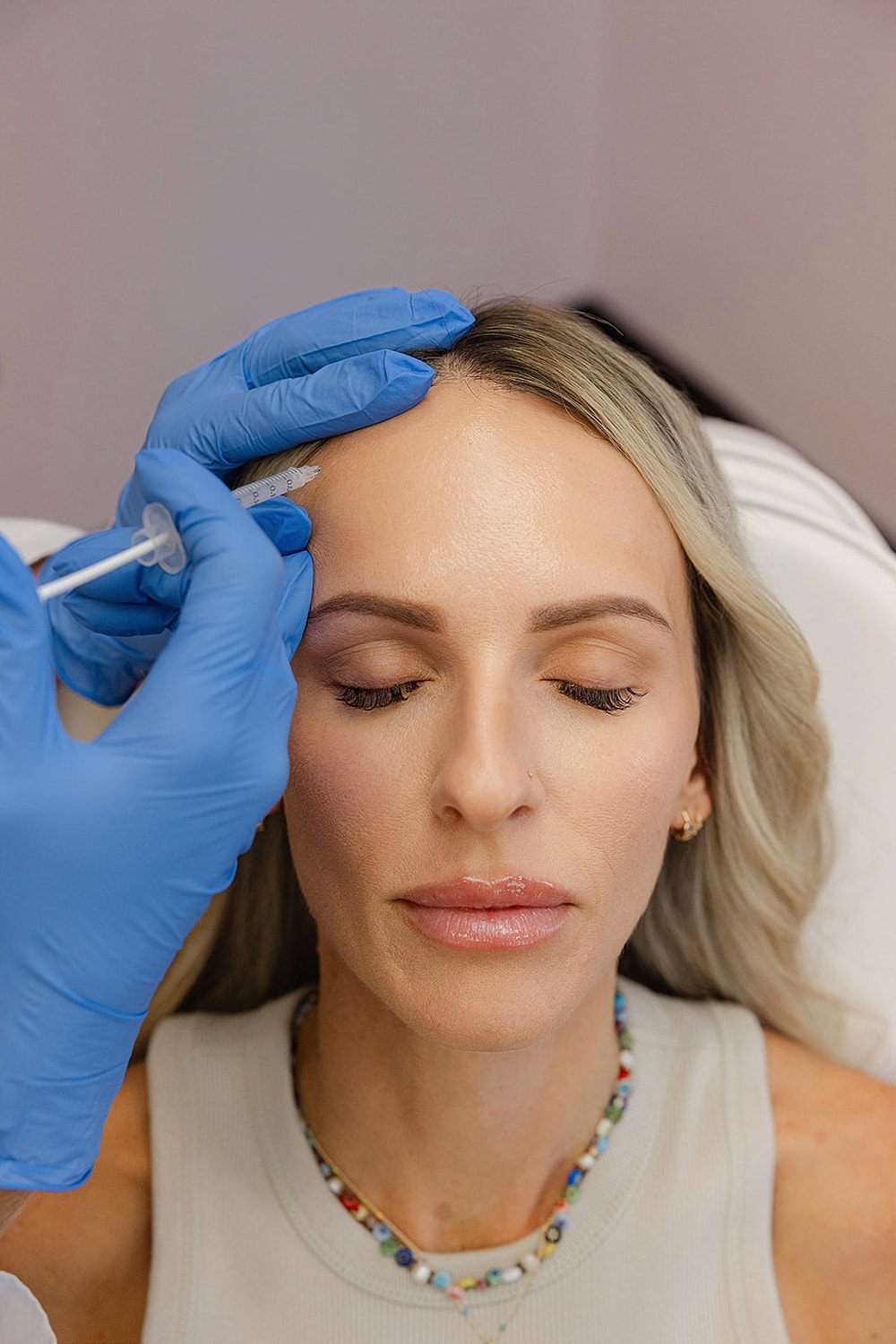 Woman receiving cosmetic treatment in a clinic.