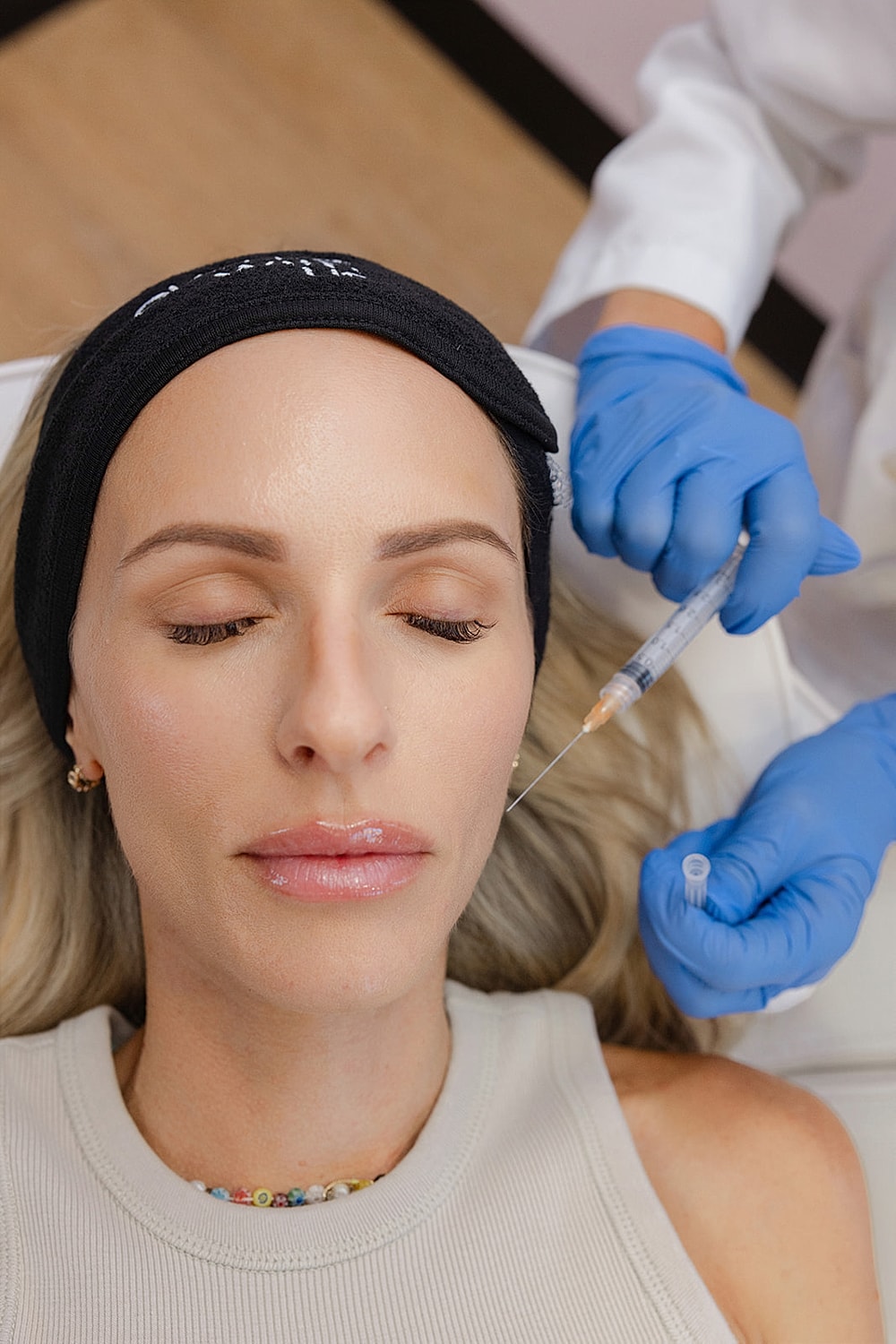 Woman receiving cosmetic injection treatment.